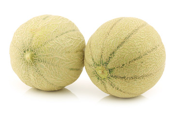 two whole cantaloupe melons on a white background