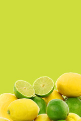freshly cut lime fruit and some lemons on a green background
