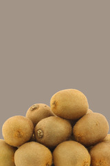 bunch of fresh kiwi fruit on a brown background