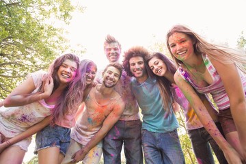 Happy friends covered in powder paint