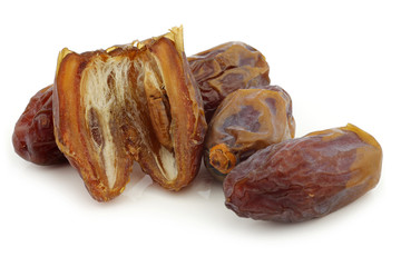 bunch of dried dates on a white background