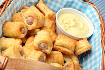Mini sausages in puff pastry with mustard sauce