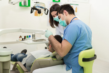 Fototapeta na wymiar Dentist Doing A Dental Treatment On Patient