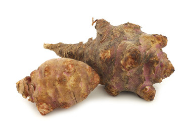 two fresh topinambur roots (helianthus tuberosus)