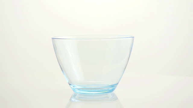 Empty glass drinking bowl. 4K UHD 2160p footage.