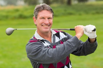 Cheerful golfer smiling at camera