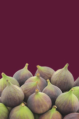fresh figs (Ficus carica) on a purple background with copy space