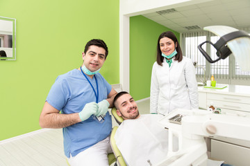 Obraz na płótnie Canvas Portrait Of A Dentist , Assistant And Patient