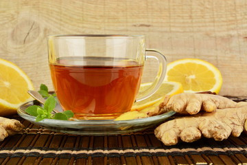 Ginger tea-ingwertee on brown mat with lemon