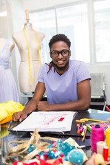 Attractive male fashion designer sketching