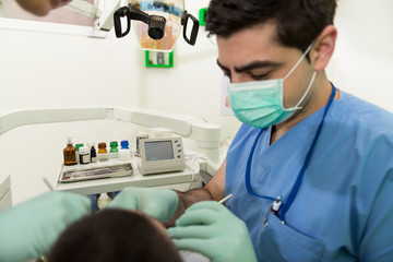 Dentist Doing A Dental Treatment On Patient