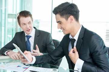 business partners discussing documents and ideas at meeting