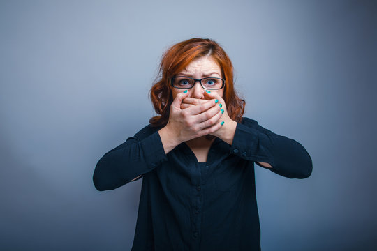 European appearance woman in glasses redhead closed mouth with h