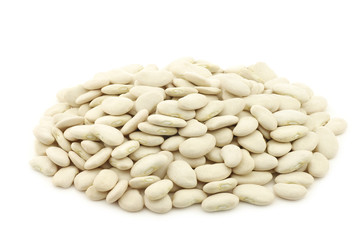 Butter beans (lima beans) in a burlap bag on a white background