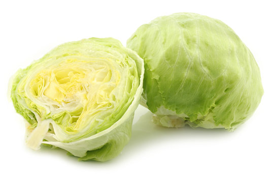 fresh iceberg lettuce and a cut one on a white background