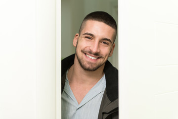 Young Man Entering Through His Front Door