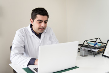 Portrait Of Male Doctor With Netbook