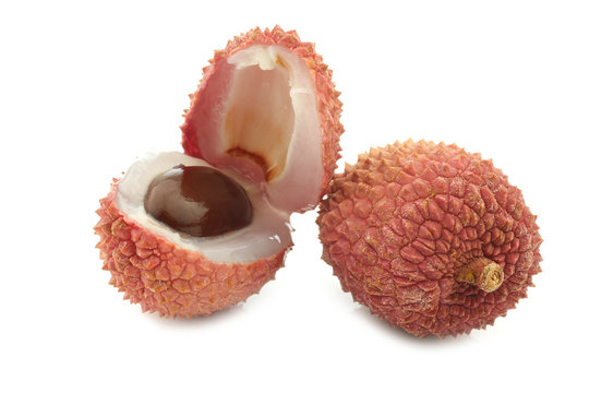  fresh lychee and a cut one on a white background
