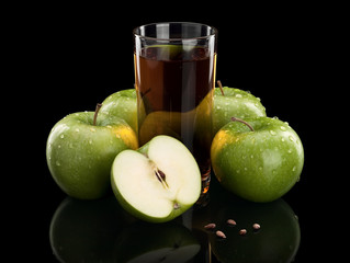 Four green apples and juice glass