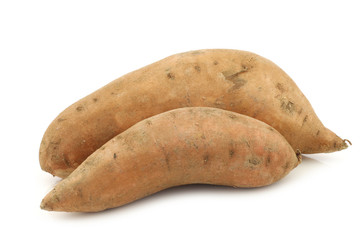 two whole sweet potatoes on a white background