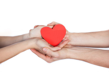 Couple in love holding a red paper heart in their hands