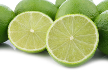 lime fruits and a cut one on a white background