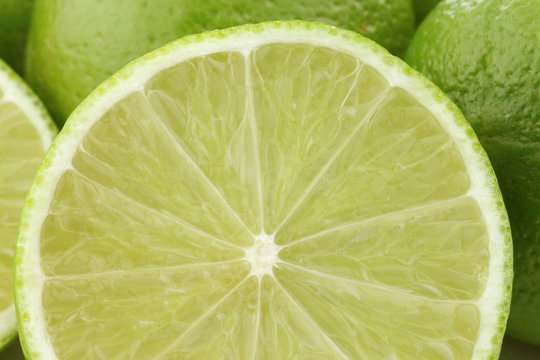 lime fruits and a cut one on a white background