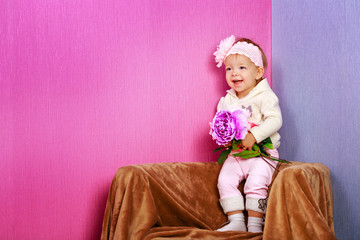 Little girl in the chair with flowers