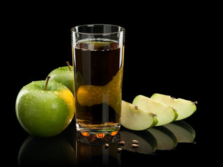 Two green apples, juice and three parts of an apple