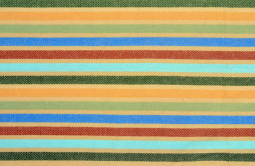 Blue, green,red colors stripes on wool fabric as a background.