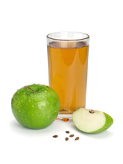 Fototapeta na wymiar Green apple, glass of juice and three parts of an apple