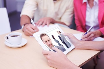 Composite image of creative team using tablet pc