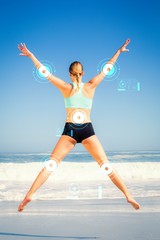 Fototapeta na wymiar Composite image of fit woman jumping on the beach with arms out