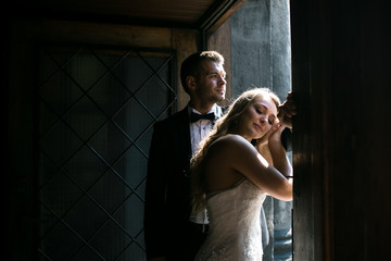 The bride and groom in a cozy house, photo taken with natural li