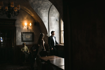 The bride and groom in a cozy house, photo taken with natural li
