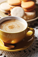 Gentle colorful macaroons and  coffee in mug