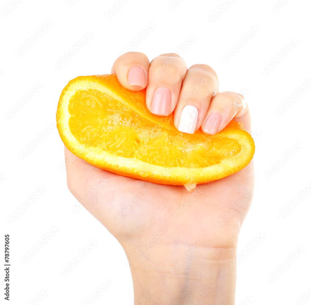 Wall mural Female hand squeezing orange isolated on white