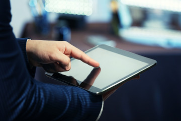 Male hand touching screen tablet close-up