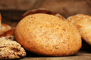 Different fresh bread on old wooden table