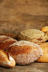 Different fresh bread on old wooden table