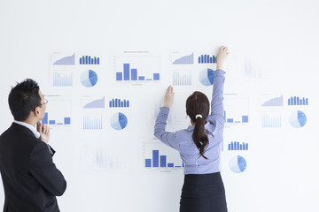 Women put a document on the wall