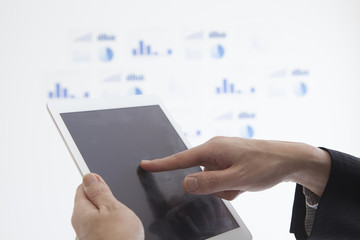 Men are using the tablet in the office