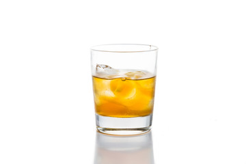A glass of of Whiskey on the rocks against white background
