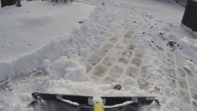 Removing snow with a shovel after winter storm