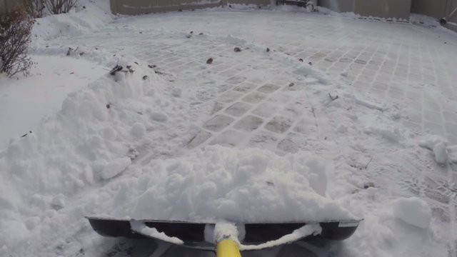 Removing snow with a shovel after winter storm