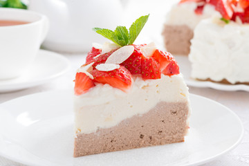 piece of cake with whipped cream, strawberries and tea