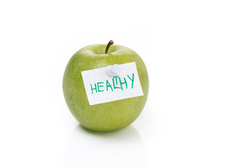 ripe green apple and label with the word healthy, isolated