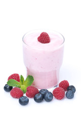 yogurt with raspberries and blueberries in a glass, isolated