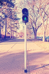 Retro filtered photo of traffic lights, green displayed.