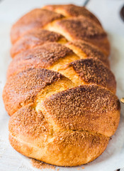wicker bun with cinnamon on a white background